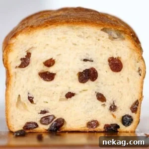 sliced sourdough raisin bread loaf with lots of raisins throughout.