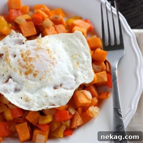 Sweet Potato Hash plated with a fried egg, ready to be enjoyed
