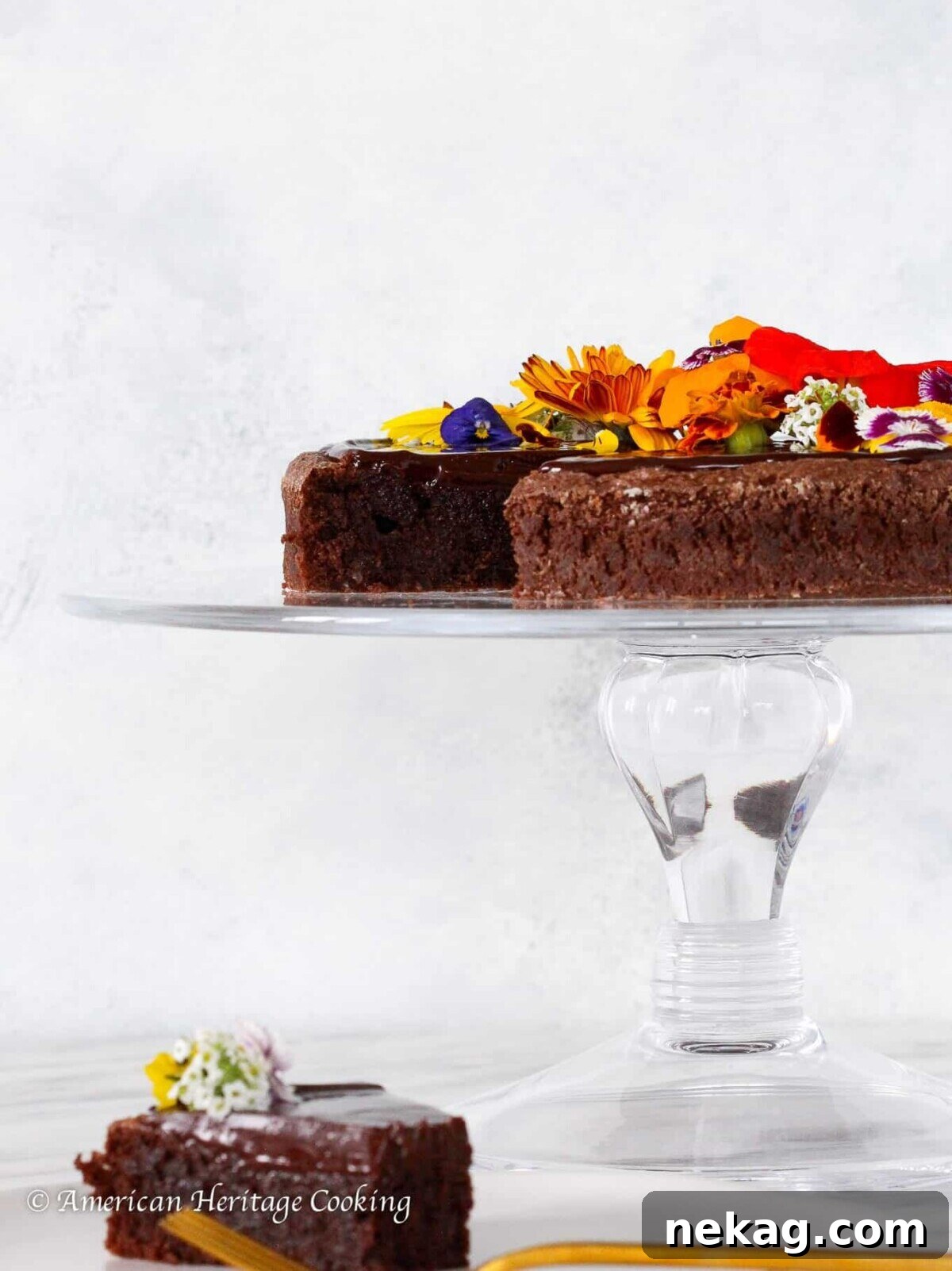 Pure Chocolate Indulgence 2 Flourless Chocolate Torte on a clear cake stand for Valentine's Day Desserts.