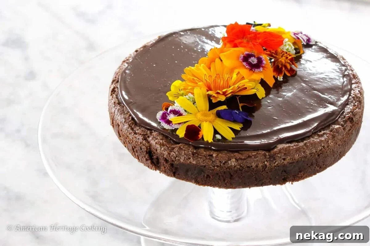 Pure Chocolate Indulgence 3 Flourless chocolate torte with edible flours arranged on top.
