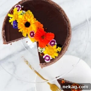 Pure Chocolate Indulgence 5 Hazelnut Flourless Chocolate Cake sliced with edible flowers.