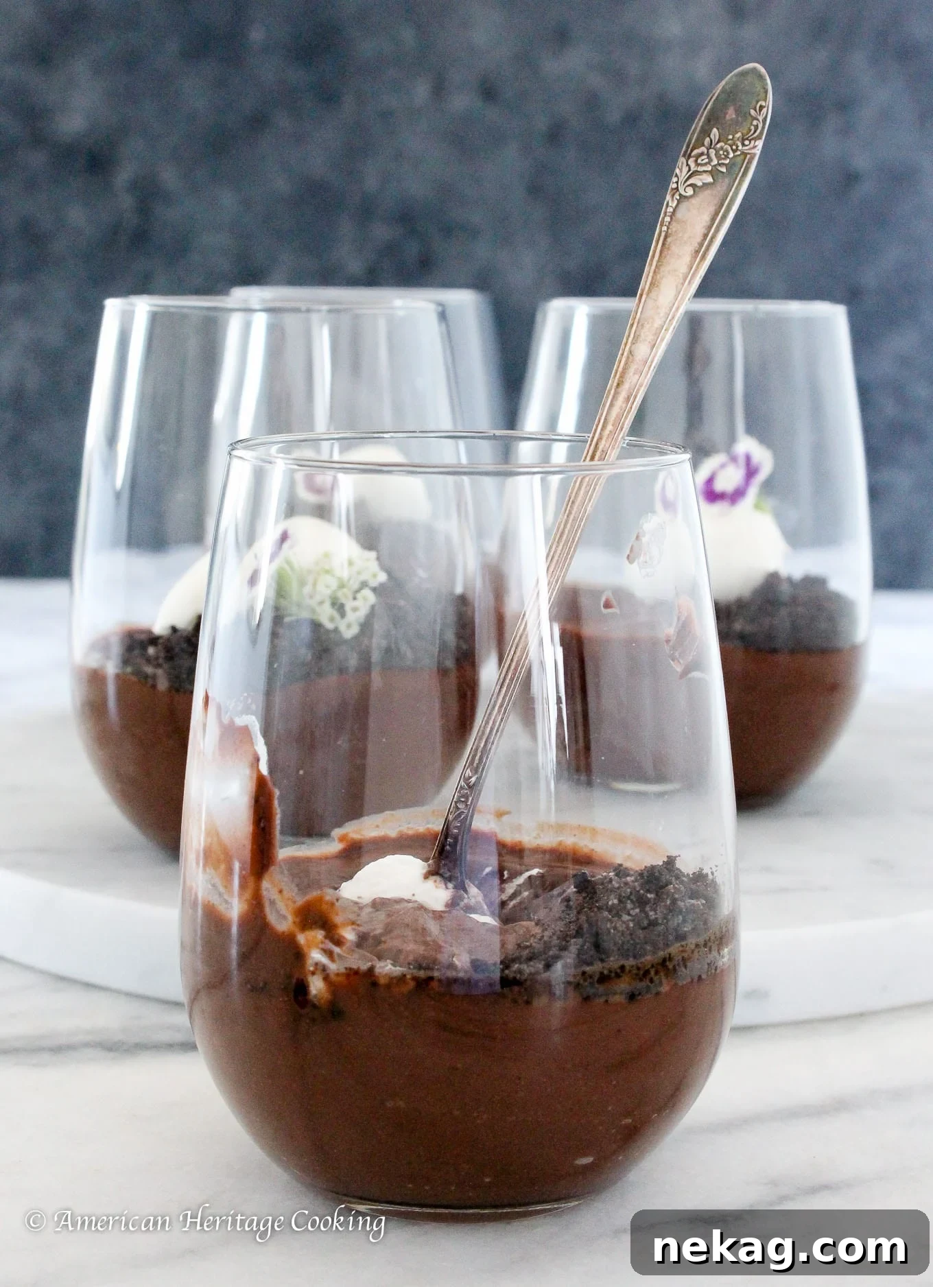 Rich Velvety Chocolate Pudding 3 Three elegant clear cups filled with luscious dark chocolate pudding, ready for serving.