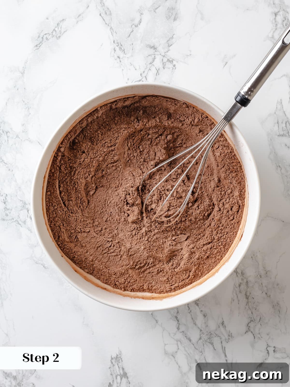 Sinfully Rich Chocolate Cake 6 A bowl filled with thoroughly mixed dry ingredients, including flour and cocoa, poised to be incorporated into the Devil’s Food Cake batter.