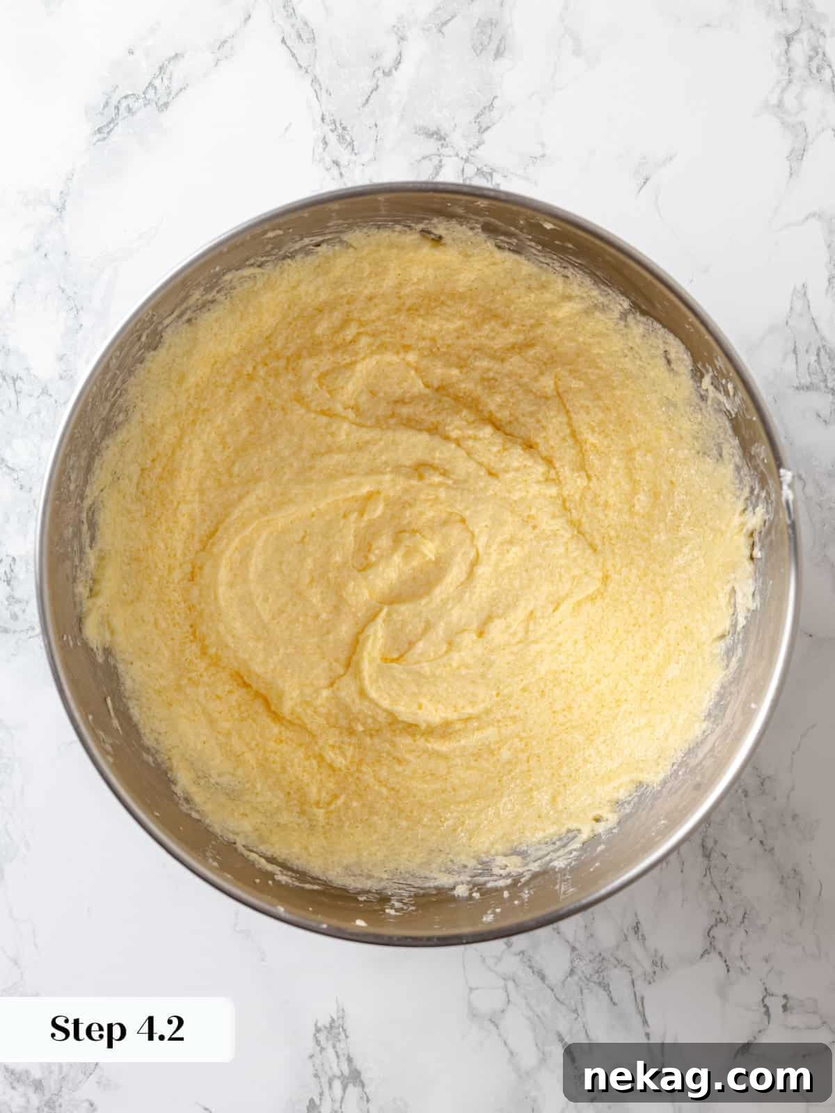 Sinfully Rich Chocolate Cake 9 The cake batter displays a smooth, consistent texture, indicating that the eggs are fully combined and emulsified into the creamed mixture.