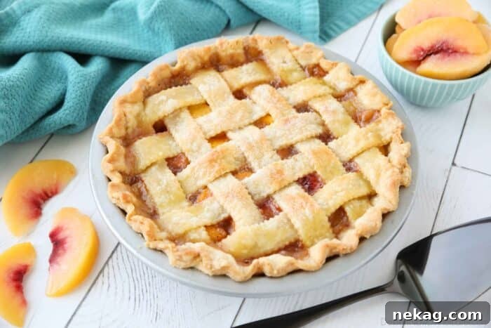 A freshly baked peach pie with a classic double crust, cooling on a wire rack.