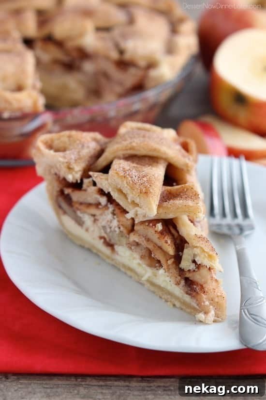 Spiced Apple Cheesecake Dream 2 Close-up of a slice of Apple Cheesecake Pie with golden crust and apple filling