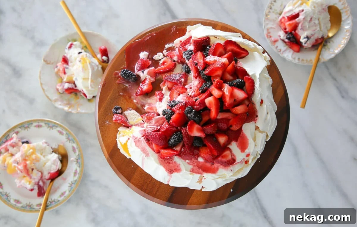 Lemon berry pavlova cake with a fresh berry topping.