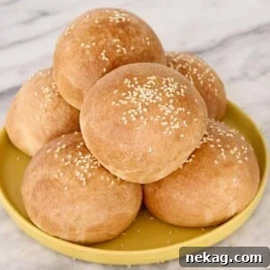 Pillowy Soft Brioche Buns 9 Stacks of golden brown brioche buns on a yellow plate, ready to serve.