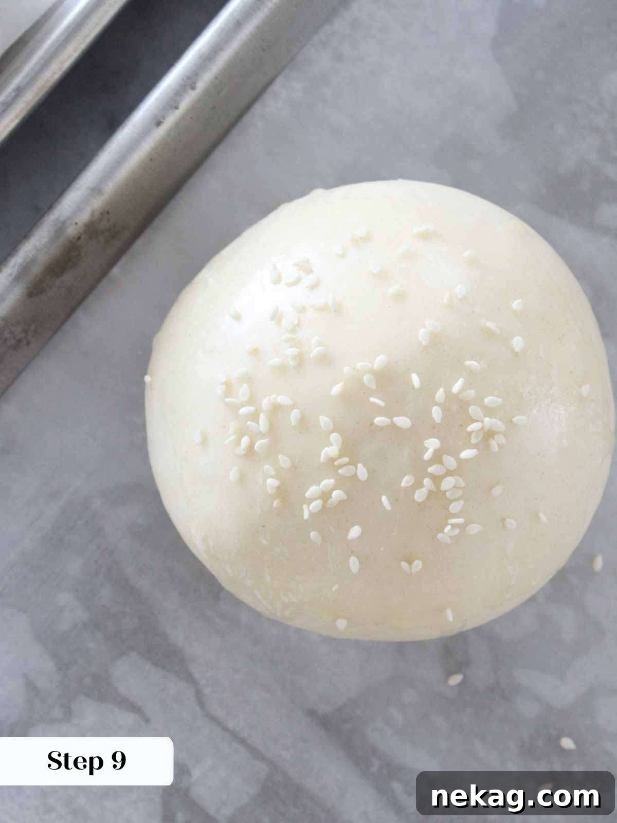 Pillowy Soft Brioche Buns 6 Unbaked brioche bun with a generous sprinkle of sesame seeds, ready for the oven.