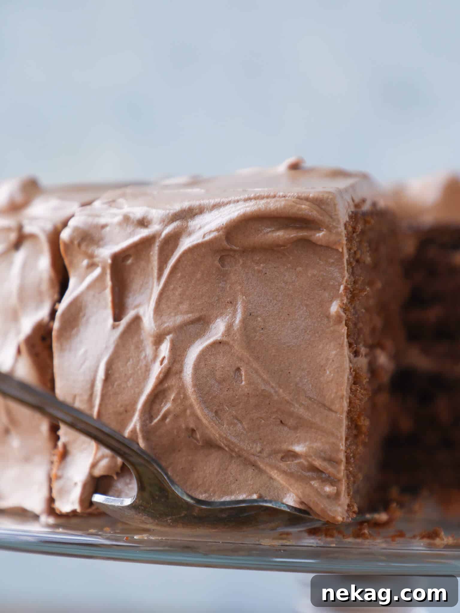 Sinful Chocolate Fudge Delight 5 A slice of Old Fashioned Chocolate Fudge Cake being served, showing the beautiful swirls of creamy icing.
