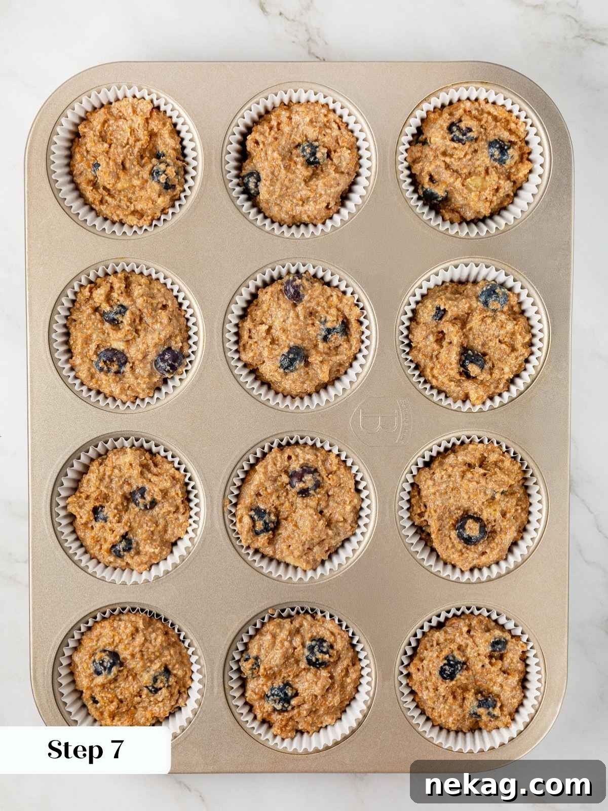 Protein-Powered Banana Muffins 11 Banana protein muffin batter evenly portioned into prepared muffin cups, awaiting their transformation into golden, delicious muffins in the oven.