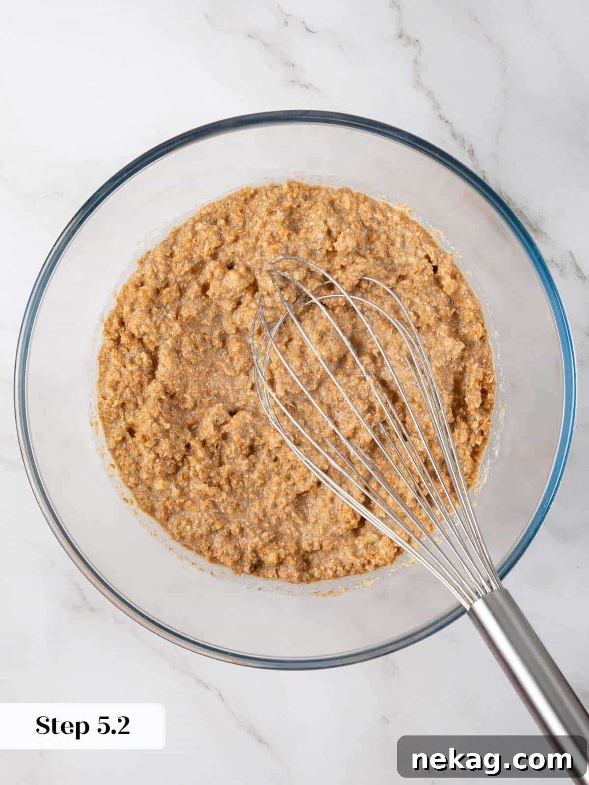 Protein-Powered Banana Muffins 7 All wet ingredients, including mashed banana, canola oil, egg whites, dark brown sugar, and vanilla extract, are thoroughly mixed until smooth, forming a cohesive base for the muffin batter.