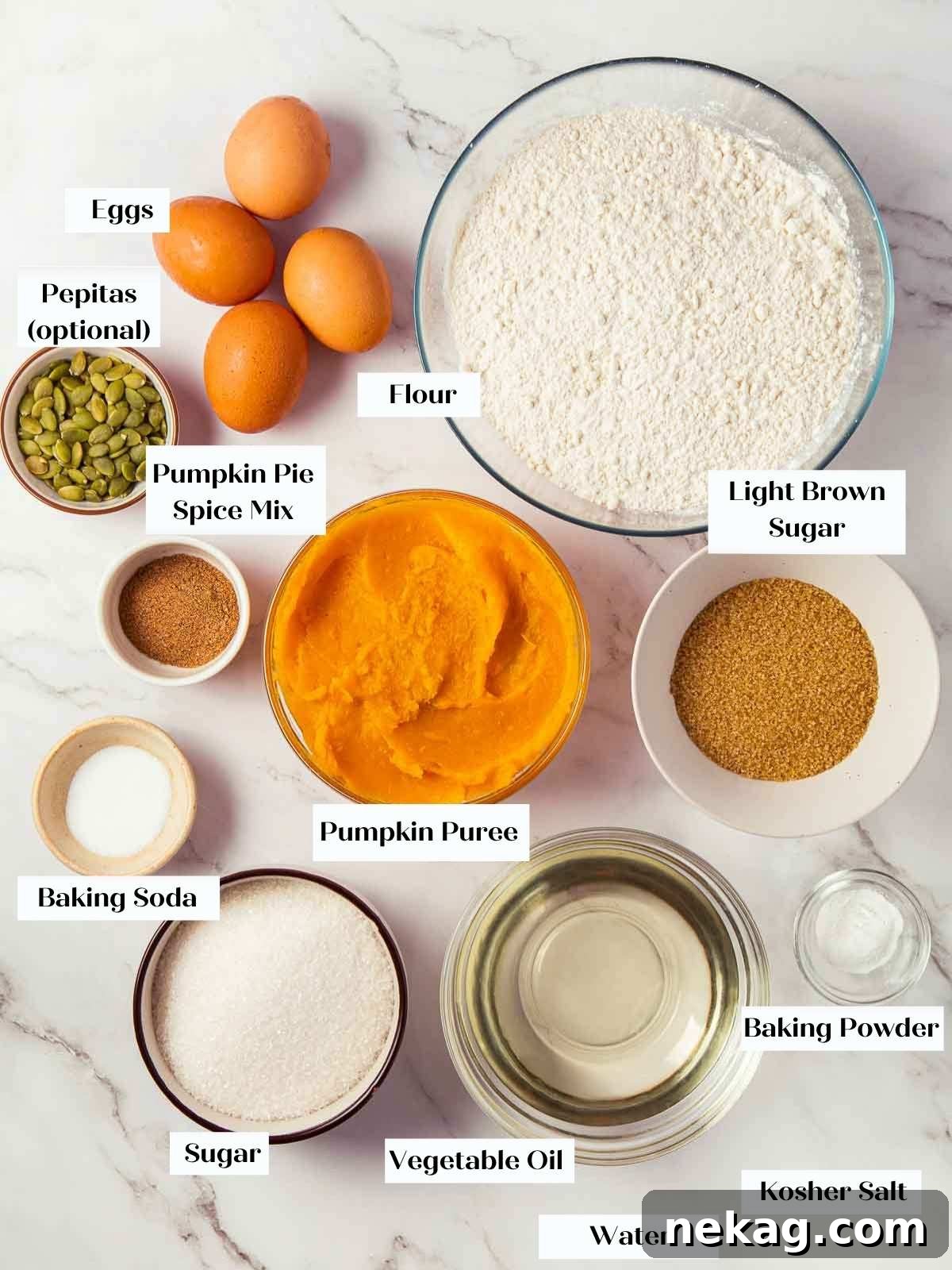 Spiced Pumpkin Delight 4 A beautiful arrangement of all the ingredients needed for pumpkin bread on a white marble countertop.