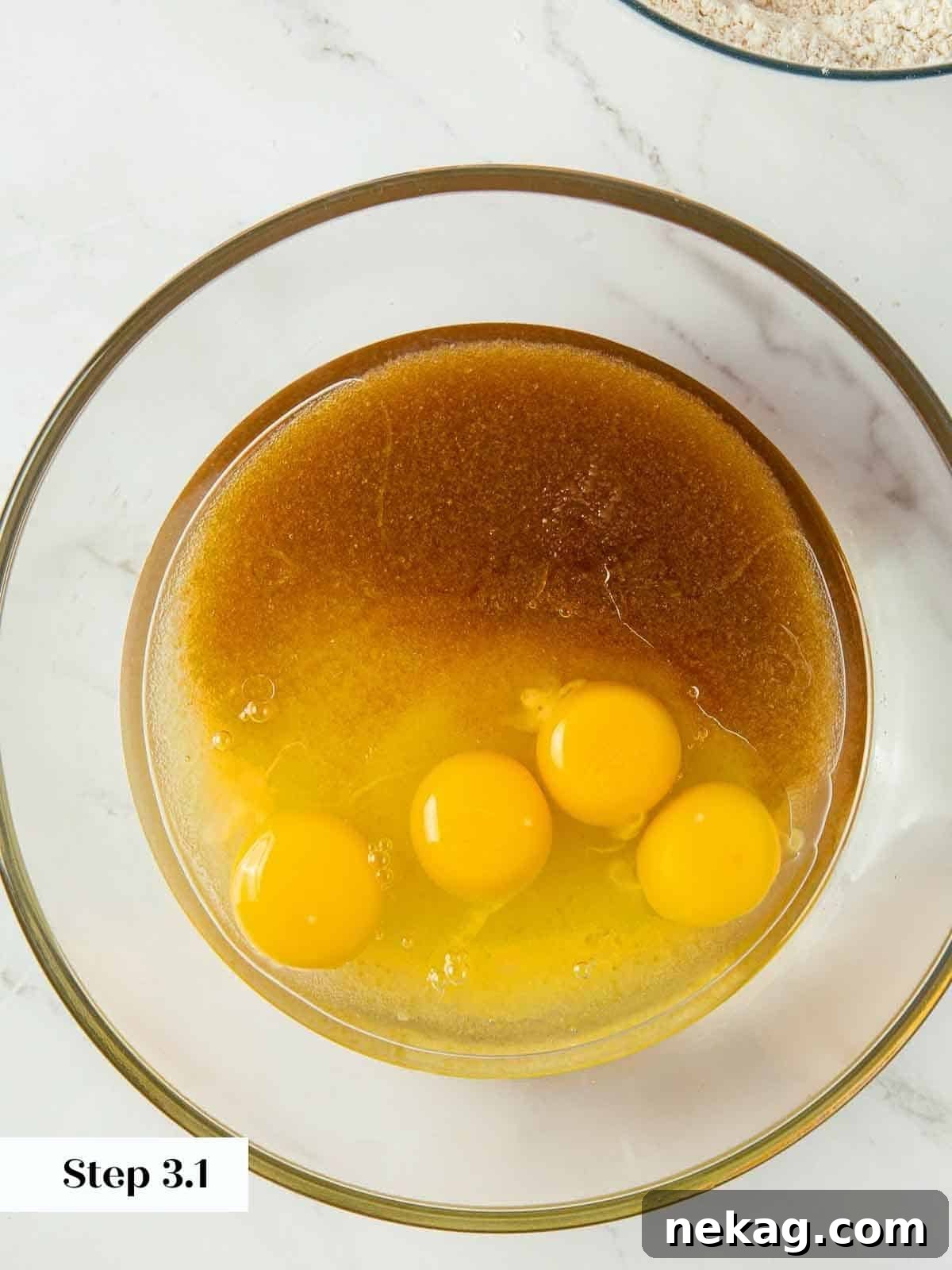 Spiced Pumpkin Delight 7 Wet ingredients for pumpkin bread in a bowl before mixing, showing sugars, oil, and eggs.