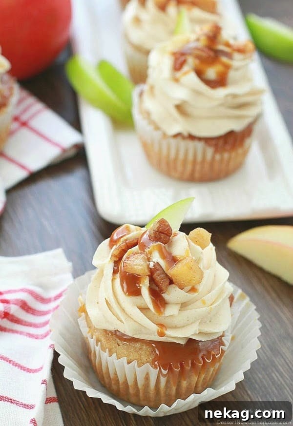 Close-up of Apple Pie Cupcakes with Salted Caramel Buttercream frosting and caramel drizzle.