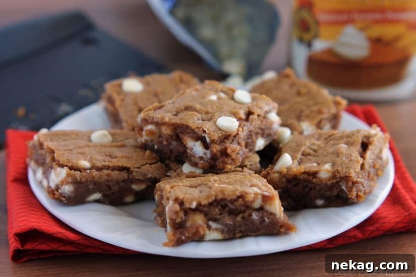 Autumn Spice Pumpkin White Chocolate Blondies 4 Close-up of fudgy Pumpkin White Chocolate Chip Blondies with melted white chocolate.
