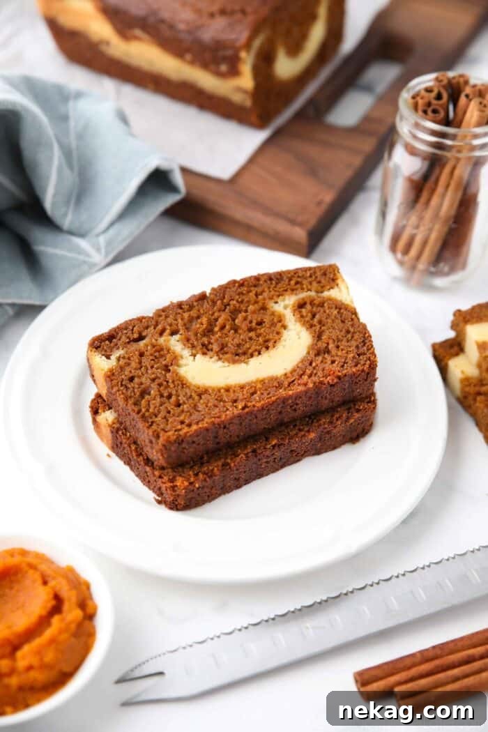Swirled Pumpkin Cream Cheese Bread 4 Slices of pumpkin cream cheese bread on a plate showing the marbled layers.