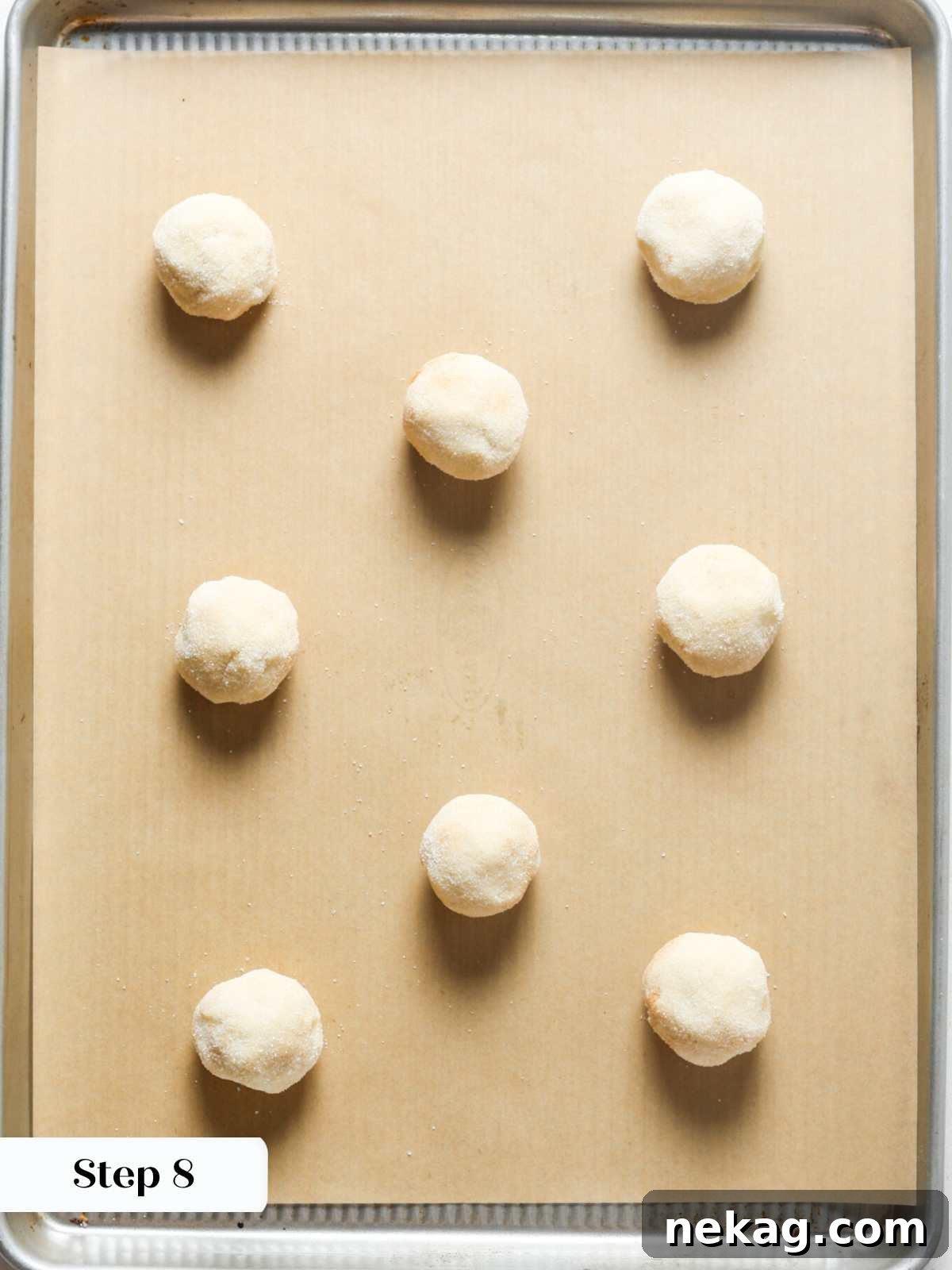 Irresistible Snickerdoodle Delights 10 snickerdoodles ready to bake on brown parchment.