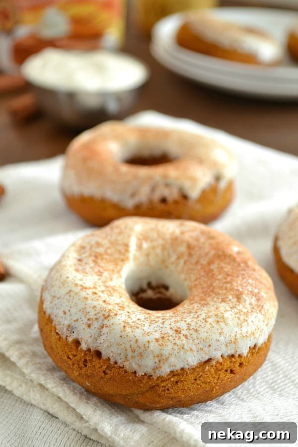 Decadent Pumpkin Spice Cheesecake Donuts 8 A top-down view of glazed Pumpkin Cheesecake Donuts.
