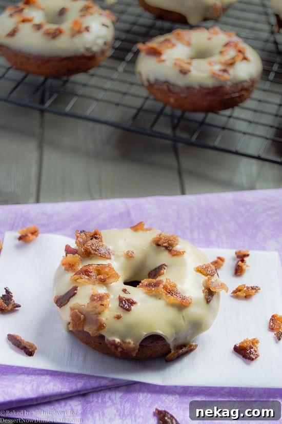 Maple Bacon Chocolate Donuts cooling on a wire rack before glazing