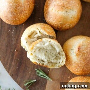 Rosemary Sourdough Rolls arranged artfully on a rustic wooden tray.