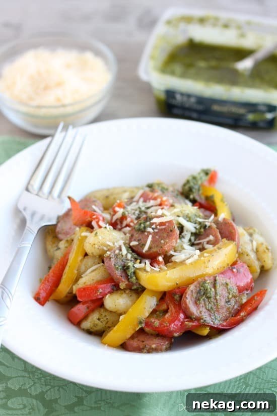 Serving of Pesto Gnocchi with Sausage and Peppers with Parmesan cheese