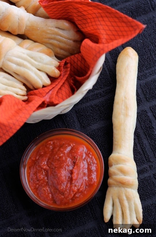 A pile of freshly baked Witch's Broomstick Breadsticks, golden and buttery, ready to be served. Ideal for Halloween parties or themed dinners.