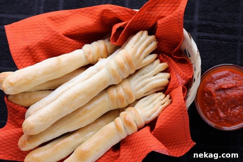 Witch's Broomstick Breadsticks made with frozen roll dough, perfectly golden brown and served in a festive setting. Great with marinara or soup!