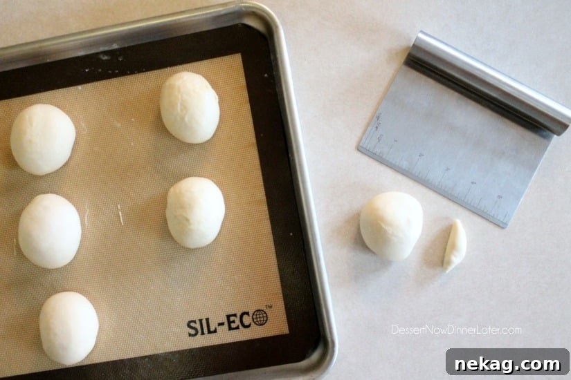 A Rhodes Dinner Roll with a tiny piece cut off, ready to be rolled into a rope for the broomstick handle and wrapping.