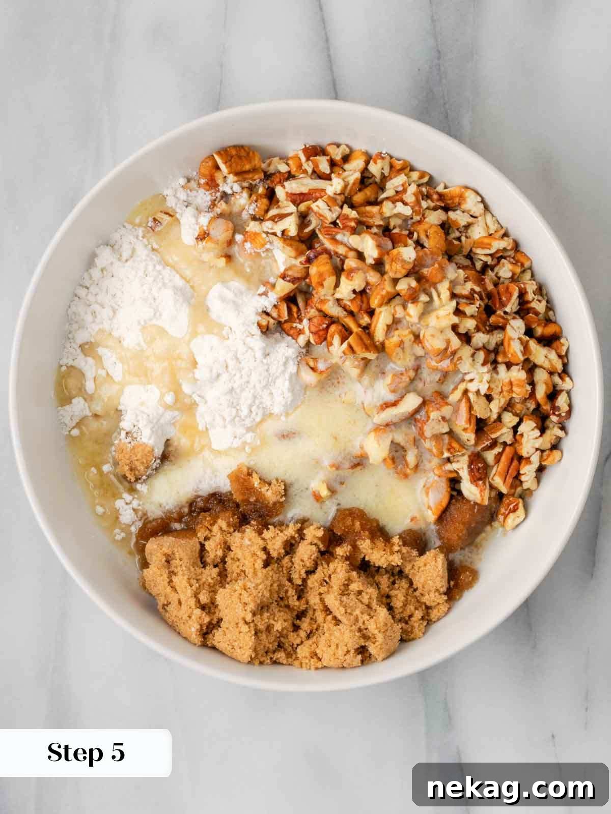 Ingredients for the pecan topping, including brown sugar, flour, butter, and pecans, in a bowl before mixing.