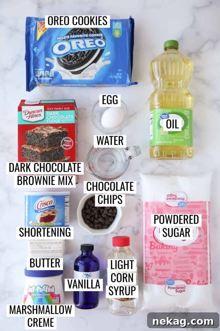 Fudgy Cookies and Cream Brownies 5 A selection of ingredients meticulously arranged for making delicious Oreo cookies and cream brownies, including a box of brownie mix, Oreos, butter, shortening, marshmallow creme, powdered sugar, chocolate chips, and other essentials.