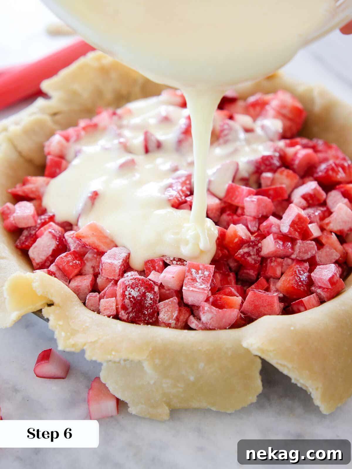 Strawberry Rhubarb Delight 5 Carefully pouring the whisked egg and sugar mixture evenly over the prepared strawberries and rhubarb in the pie crust, ensuring full coverage.