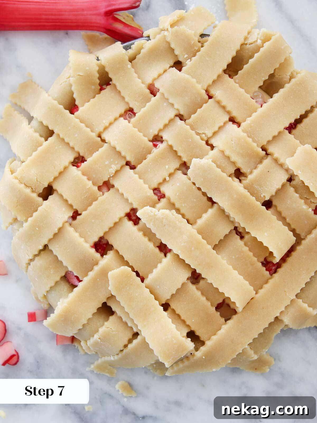 Strawberry Rhubarb Delight 6 The delicate process of latticing a pie crust on top of the vibrant strawberry rhubarb filling, creating a beautiful design.