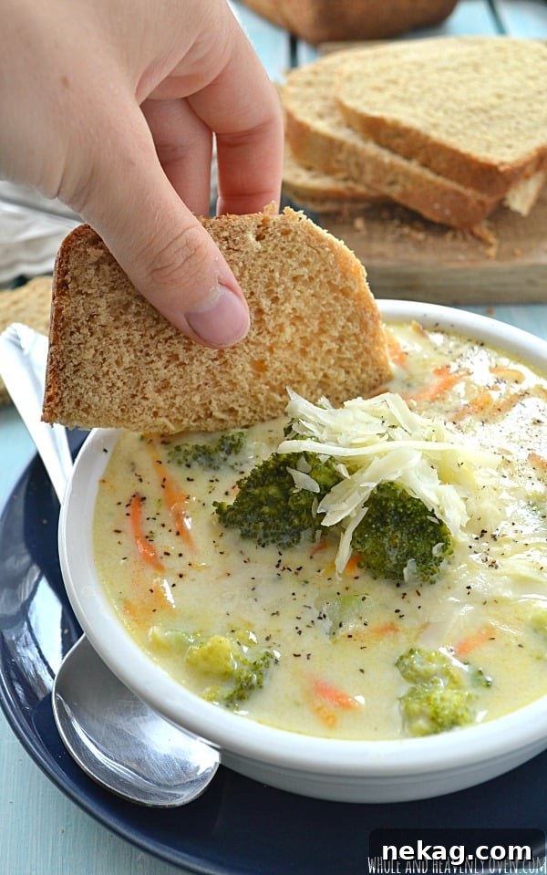 Velvety Broccoli Cheese Soup 9 Serving of broccoli cheese soup with a side of crusty bread