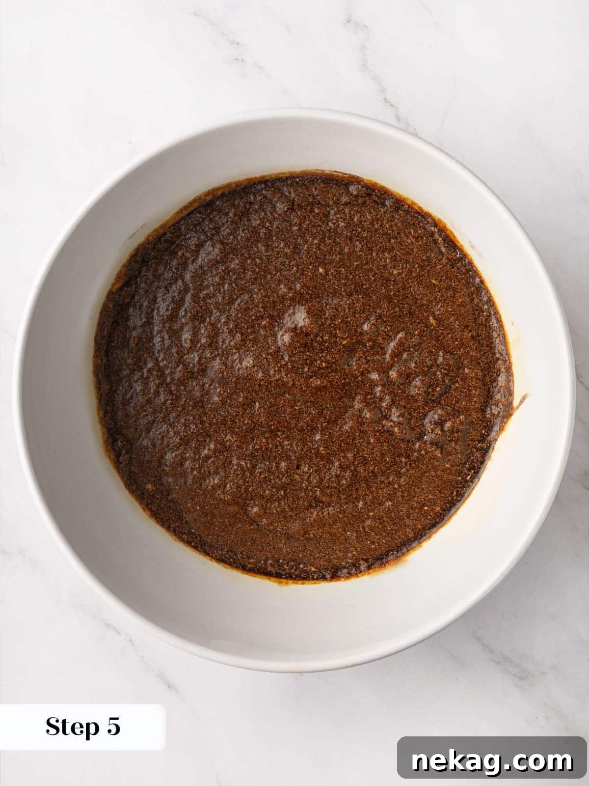 Butter and sugar beaten together in a bowl until creamy as the first mixing step.