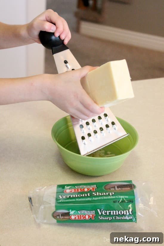 A block of high-quality Cabot Vermont Sharp Cheddar cheese, essential for a rich and creamy mac and cheese sauce.