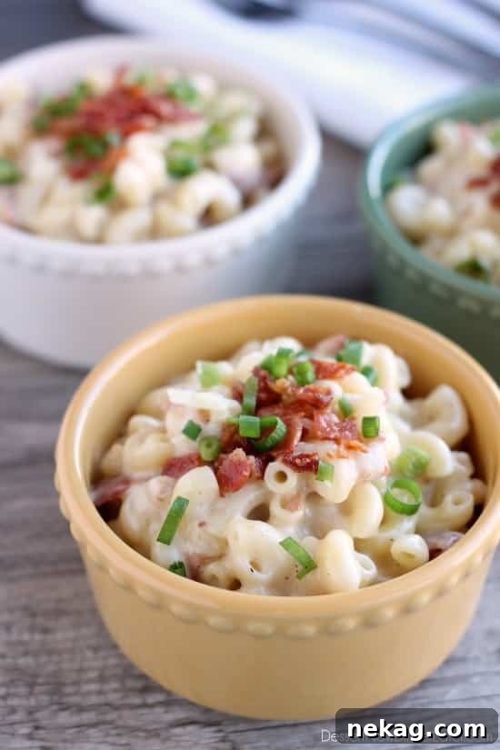 A final beautiful image of White Cheddar Bacon Mac and Cheese in a serving dish, inviting and warm, with steam subtly rising from the cheesy goodness.