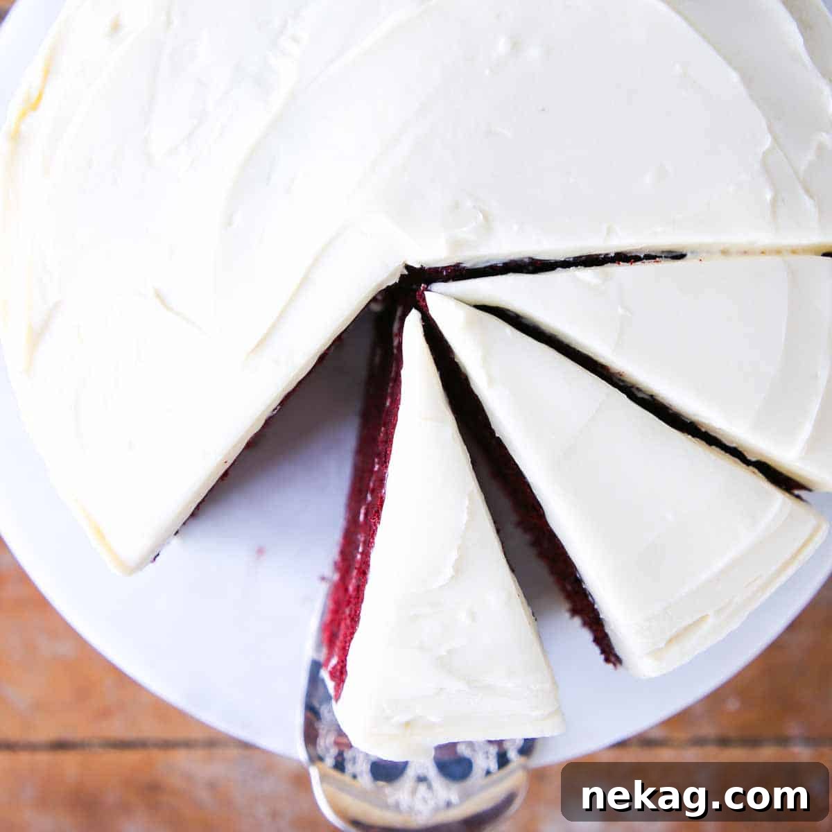 Slice of red velvet cake topped with bourbon cream cheese buttercream.