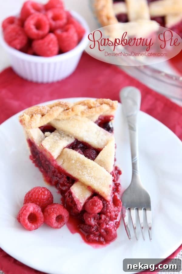 A beautifully baked Raspberry Pie with a golden lattice crust, ready to be served. Made with fresh or frozen raspberries for a delicious dessert.