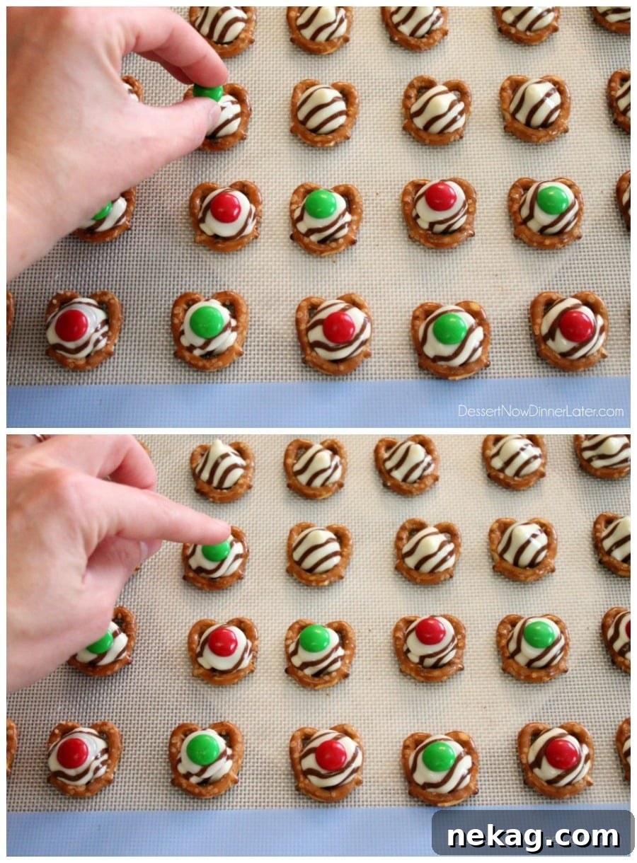 How to Make Adorable Christmas Pretzel Hugs 3 A baking sheet filled with mini pretzels topped with Hershey's Hugs, ready to be baked into Christmas treats.
