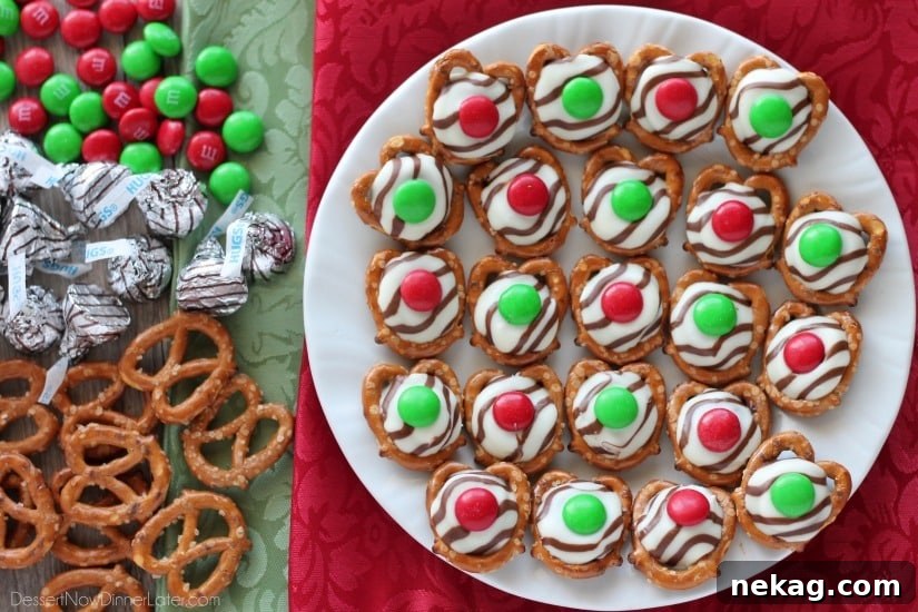 How to Make Adorable Christmas Pretzel Hugs 4 Close-up of a finished Christmas Pretzel Hug with a red M&M on top, showcasing the melty chocolate and crisp pretzel.