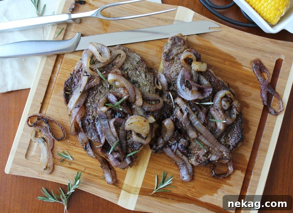 Close-up of a perfectly seared Rib-Eye steak with a savory rosemary crust on a hot grill pan.