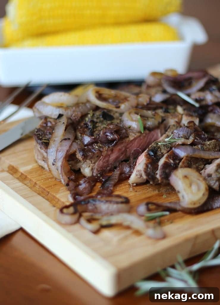 Close-up of a perfectly sliced Rib-Eye steak, revealing its juicy, pink medium-rare interior, resting on a cutting board.