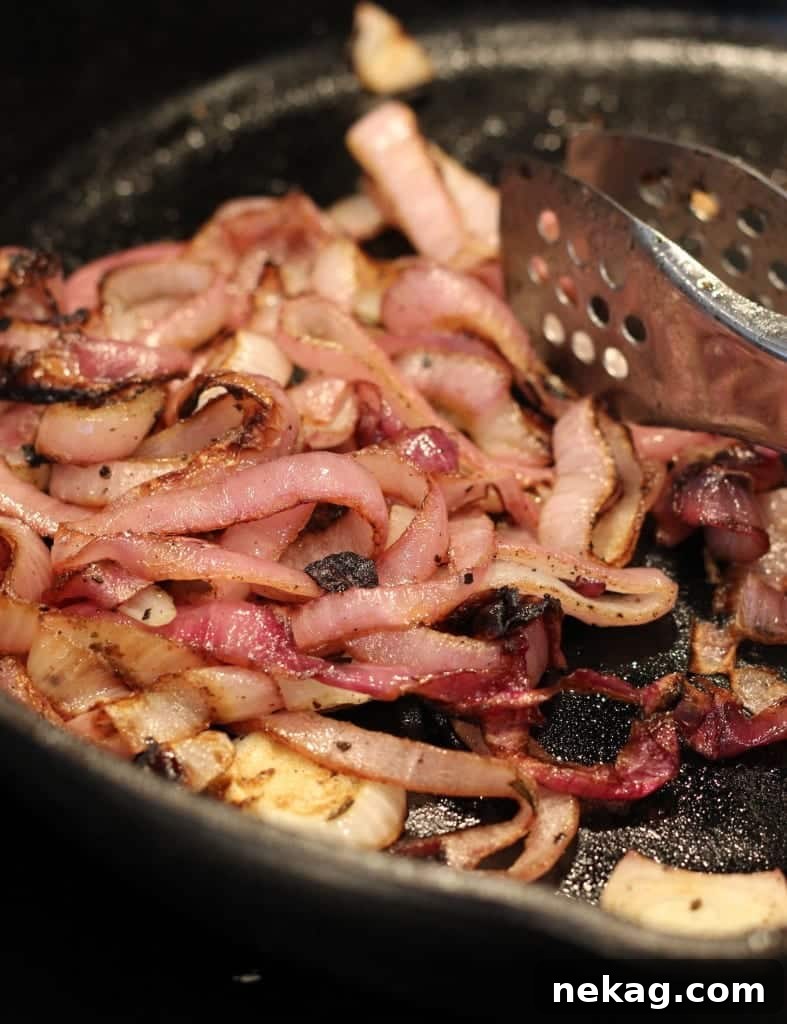Perfectly charred red onion slices showcasing beautiful caramelization and a slight smoky crisp.