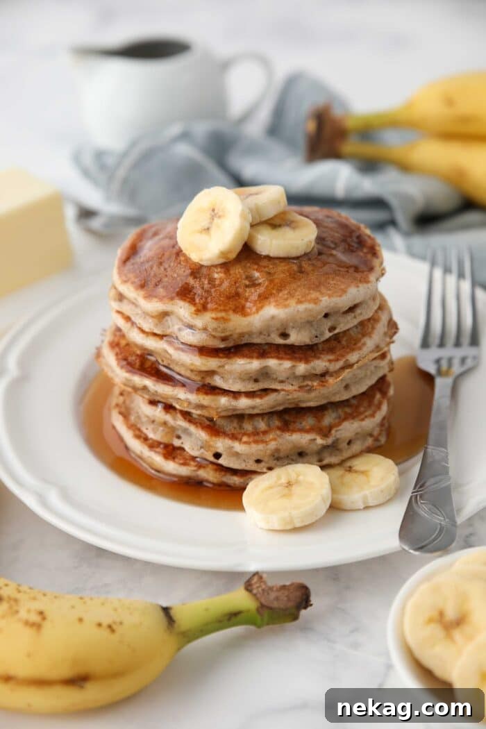 Stack of fluffy banana pancakes made with a pancake mix.