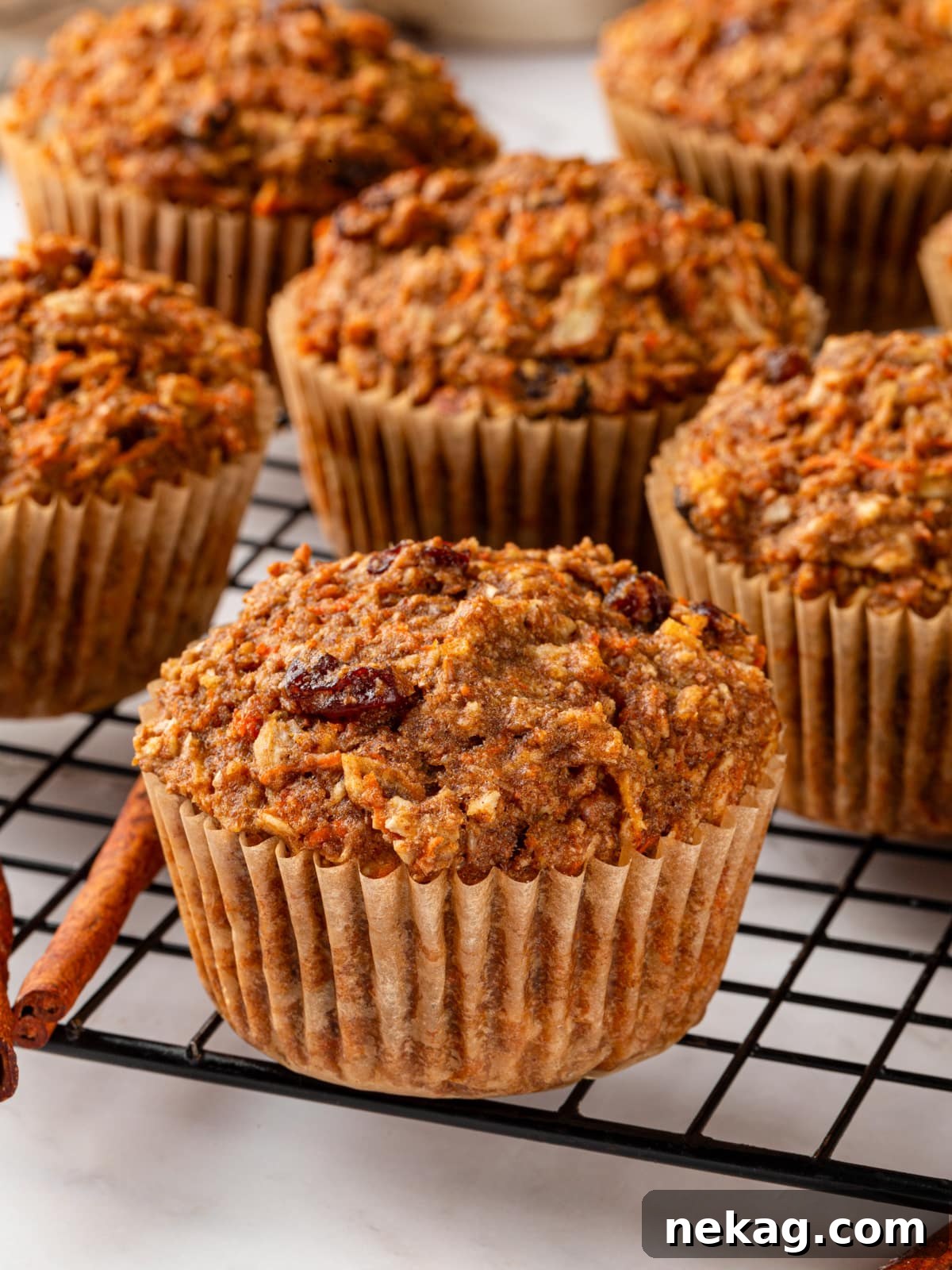 A simple yet inviting presentation of freshly baked morning glory muffins resting on a cooling rack after emerging from the oven.