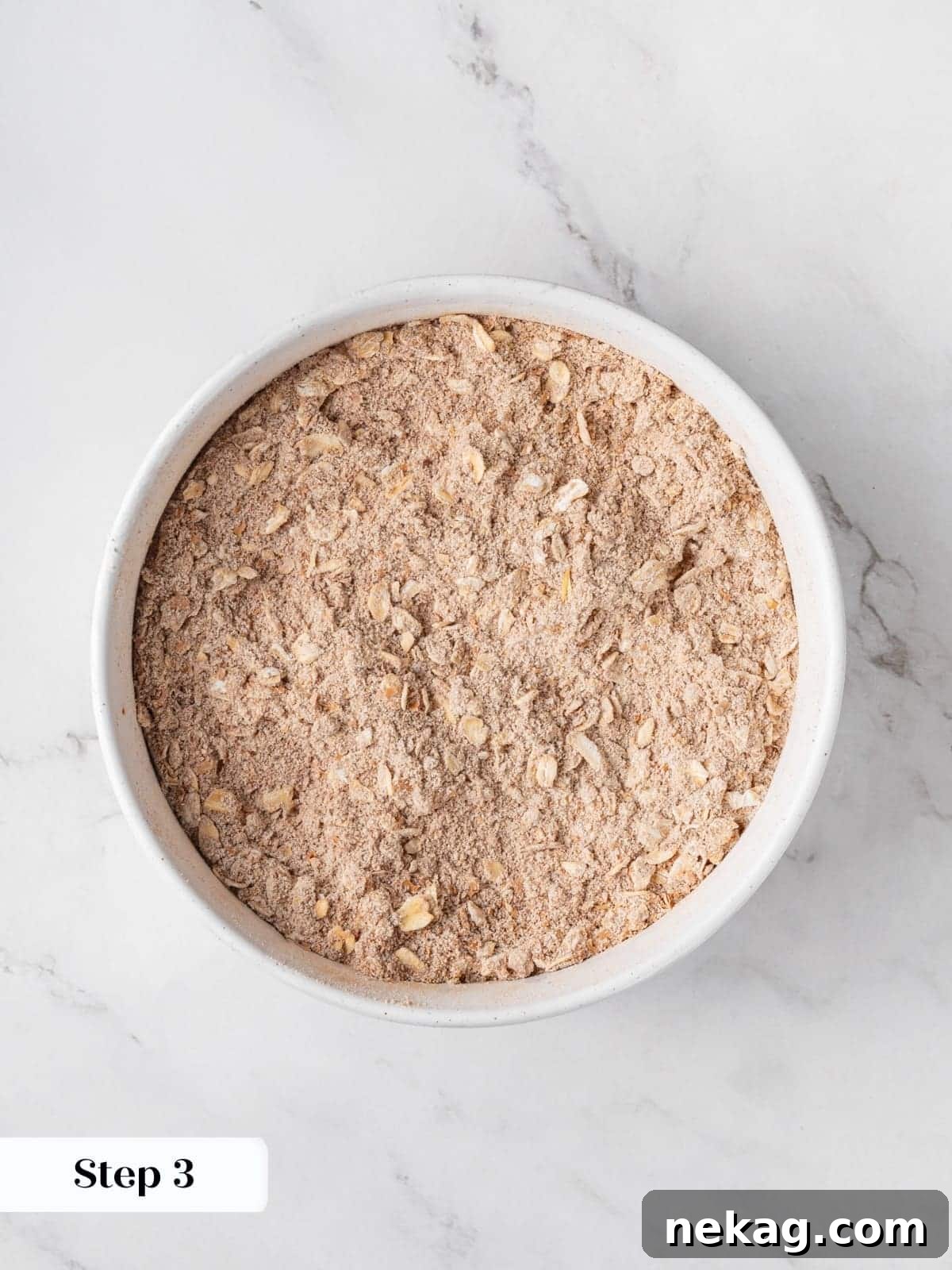 Dry ingredients for morning glory muffins are perfectly mixed in a bowl, awaiting the wet ingredients to form the batter.