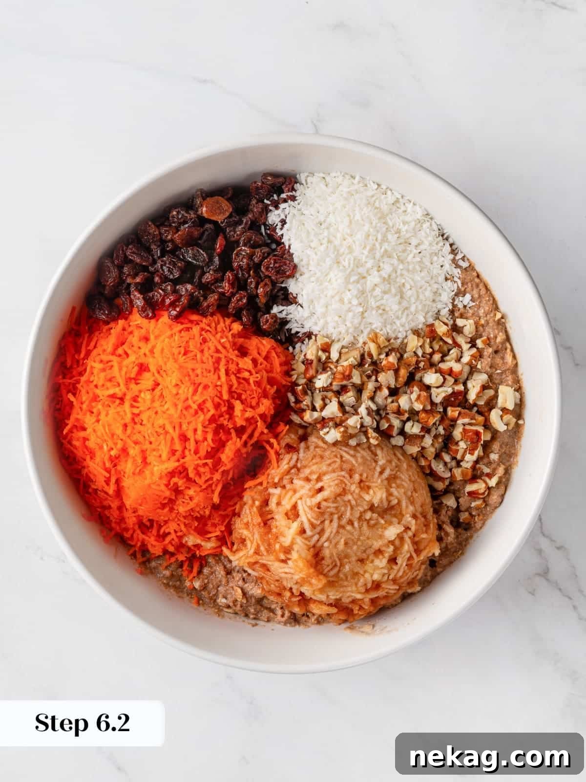 All the wholesome additions – fruits, nuts, and vegetables – being gently folded into the morning glory muffin batter.