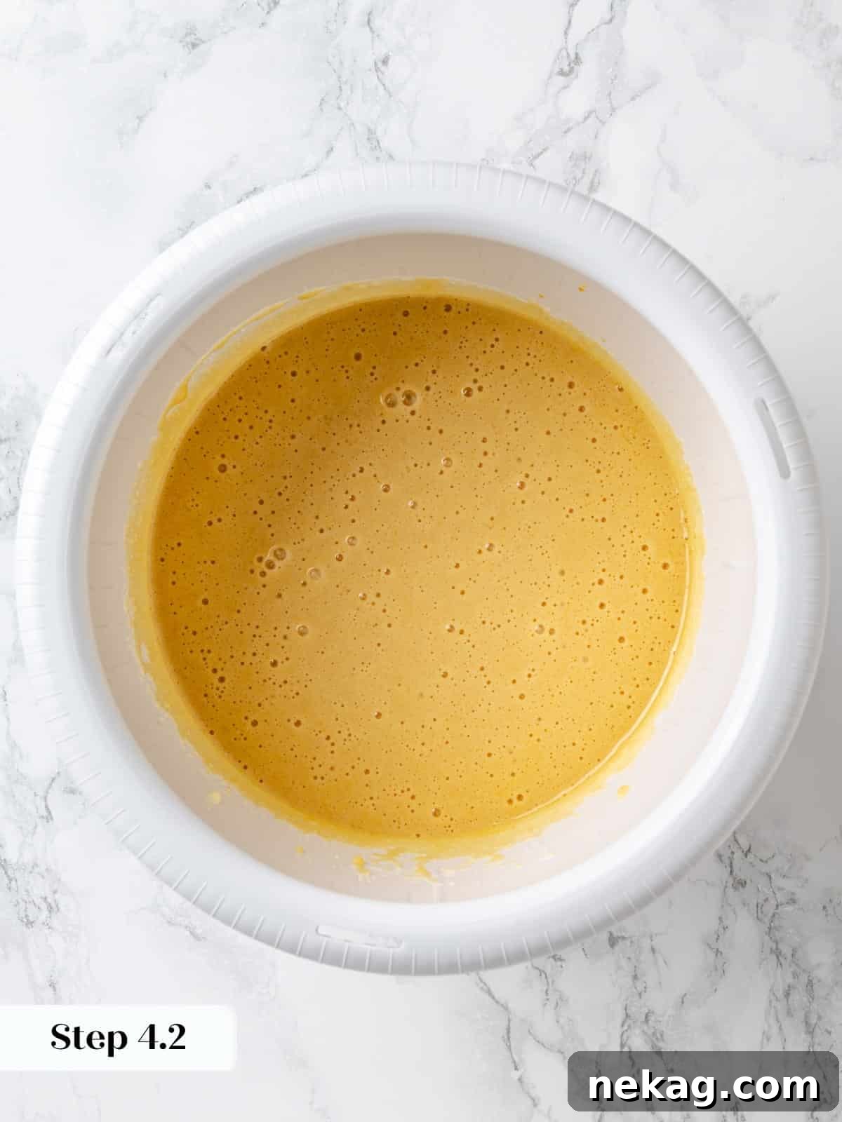 Wet ingredients mixed together with coffee until smooth, forming a glossy chocolate batter.