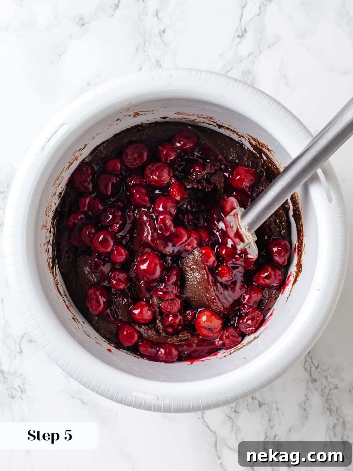 Tart cherries stirred through the chocolate cake batter to evenly distribute fruit throughout the mix.
